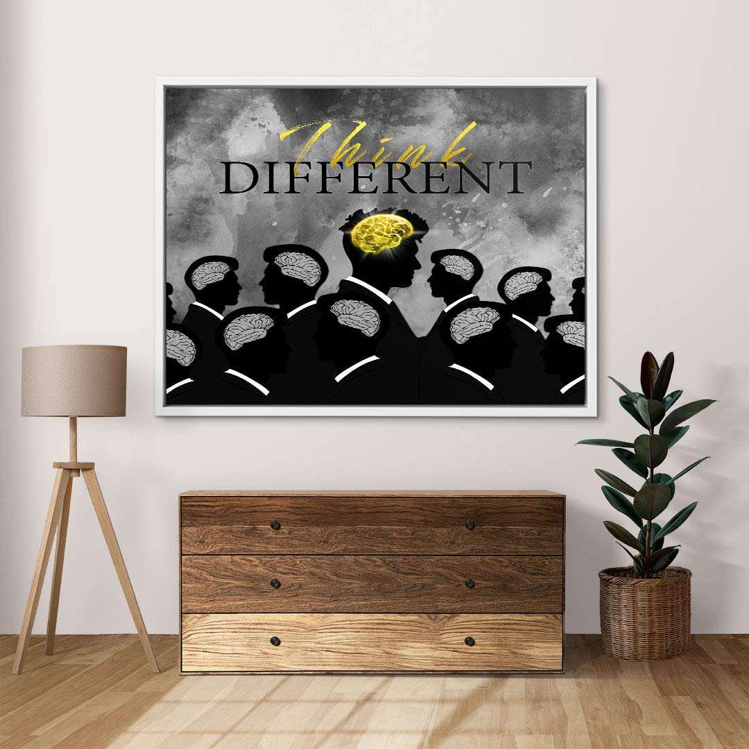 Modernes Wandbild mit mehreren Silhouetten, zentral eine Figur mit goldfarbenem Gehirn und Text 'Think Different', Motivationskunst für Wohnzimmer.