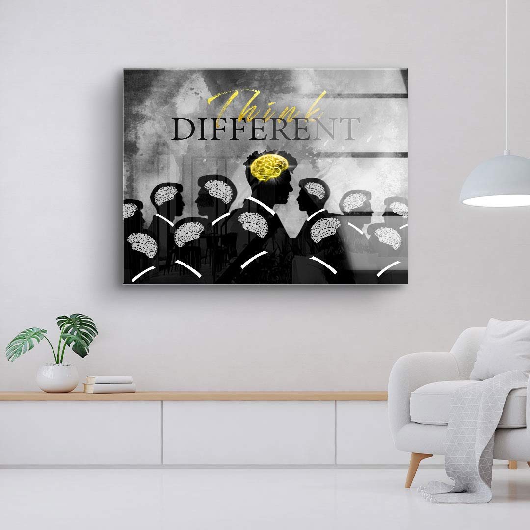 Modernes Wandbild mit schwarzen Silhouetten, Gehirnen und gelbem Akzent, Aufschrift 'Think Different'
