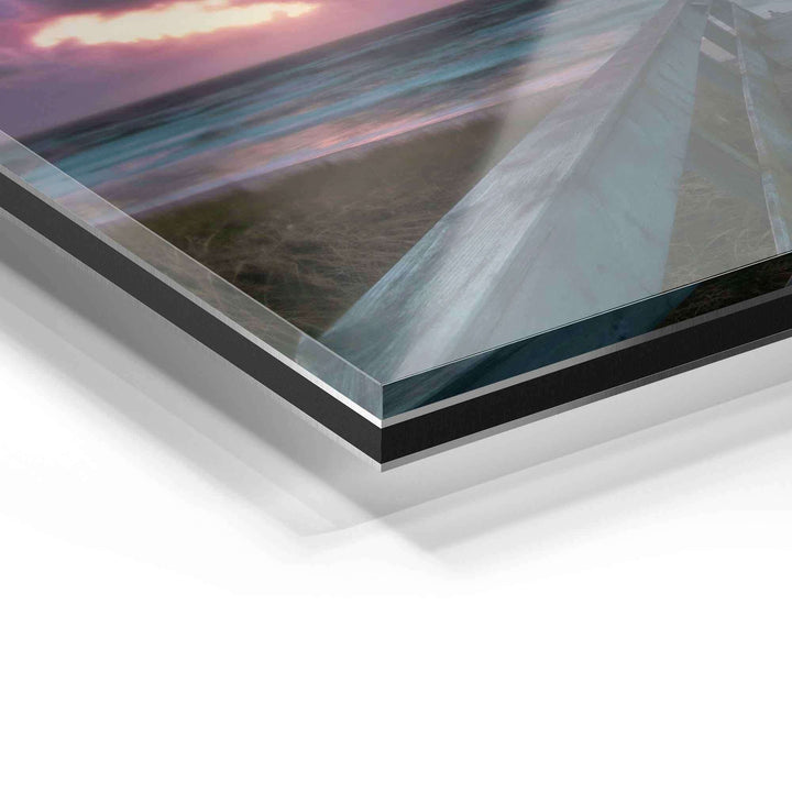Detailansicht eines Wandbilds auf Acrylglas mit Meeresmotiv und Sonnenuntergang.