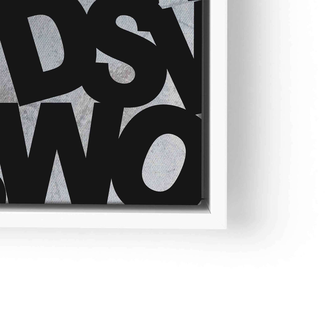 Detail eines modernen Motivationsbilds mit schwarzer Schrift auf grauem Hintergrund im weißen Rahmen