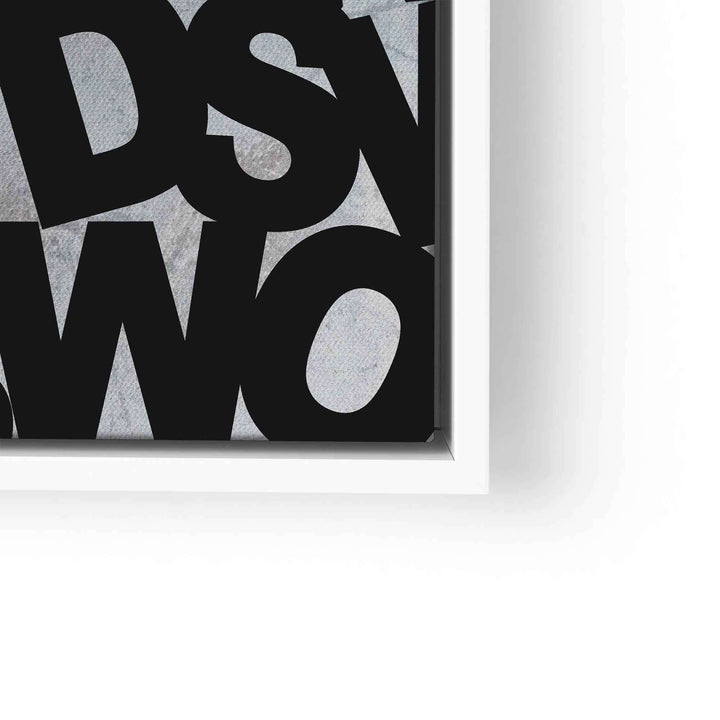 Detail eines modernen Motivationsbilds mit schwarzer Schrift auf grauem Hintergrund im weißen Rahmen