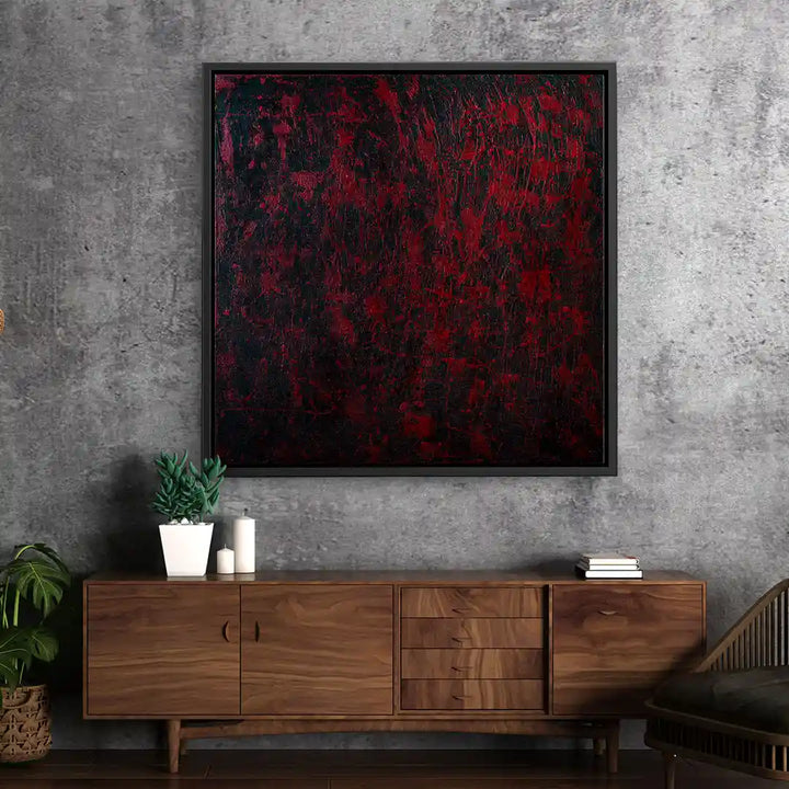 Modernes abstraktes Wandbild in Rot und Schwarz auf Betonwand über Holzkommode