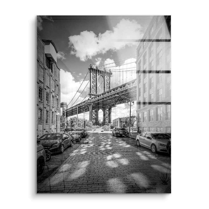 Schwarzweiß Wandbild der Manhattan Bridge mit Autos und Backsteingebäuden in Straßenansicht