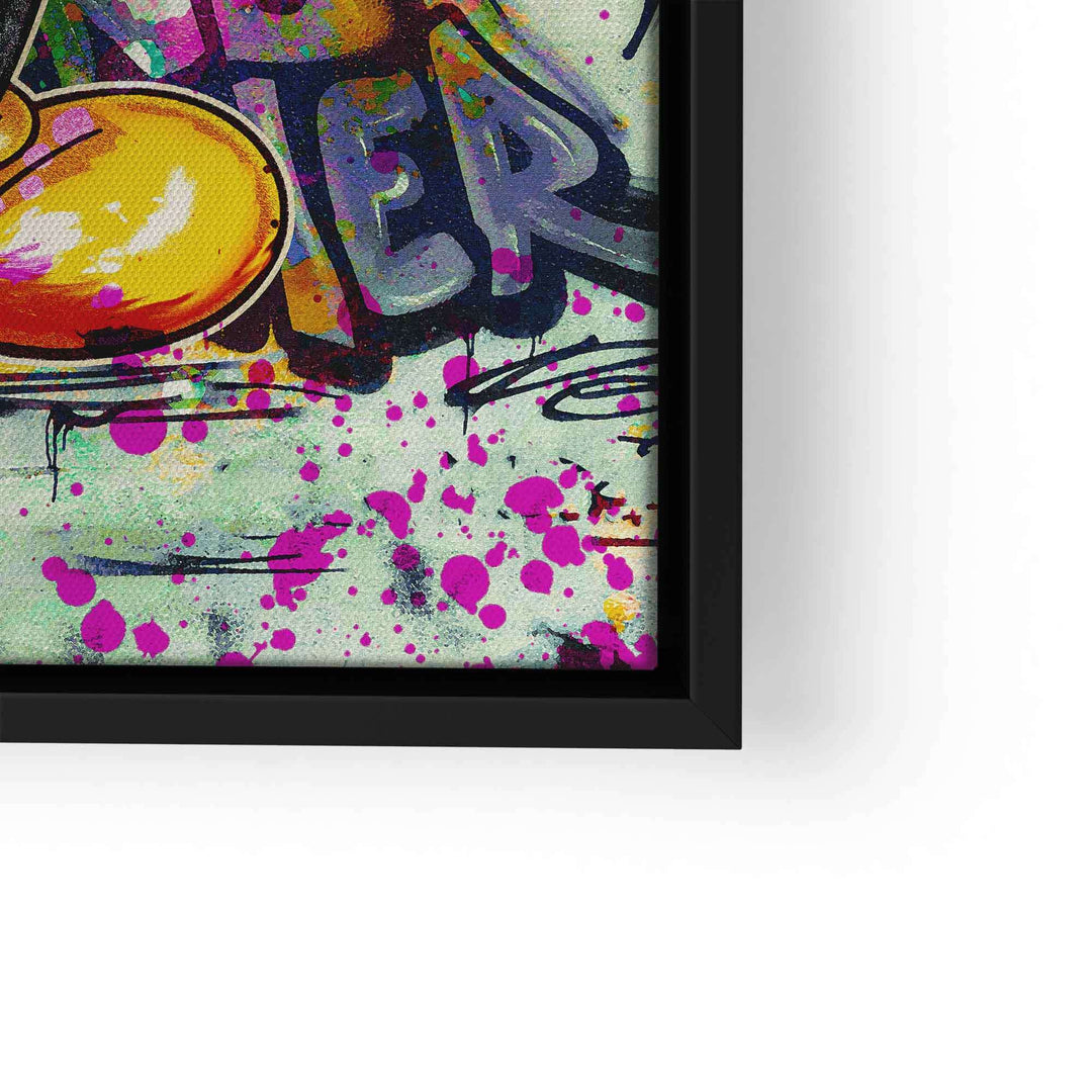 Detail eines Wandbilds im Graffiti-Stil mit bunten Farbspritzern und Comic-Elementen