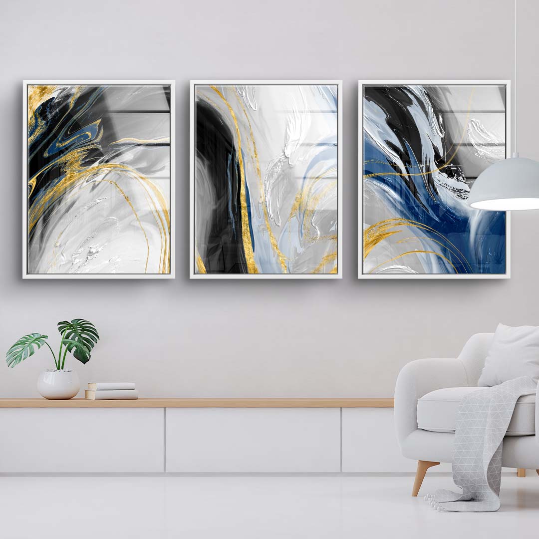 Modernes Wandbild-Set mit abstrakten Farbverläufen in Gold, Blau, Schwarz und Weiß im Wohnzimmer