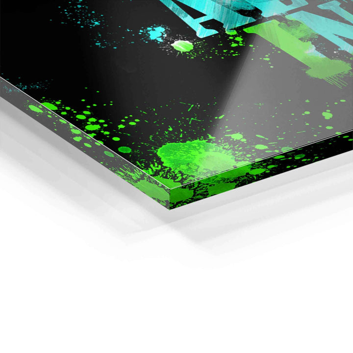 Acrylglas Wandbild Detail mit grünen Farbspritzern auf schwarzem Hintergrund