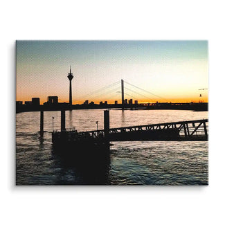Wandbild mit Sonnenuntergang am Fluss, Skyline und Brücke, modernes Leinwandbild
