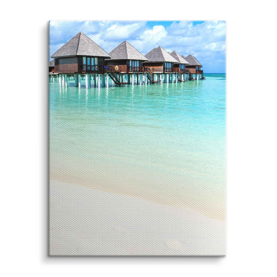 Wandbild mit tropischem Meer, Pfahlbauten und türkisblauem Wasser auf Leinwand