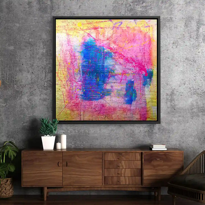Abstraktes Wandbild mit kräftigen Farben in Blau, Pink und Gelb an grauer Wohnzimmerwand